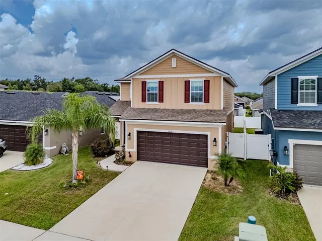 an aerial view of a house with a garden and plants