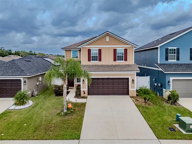an aerial view of a house with a yard