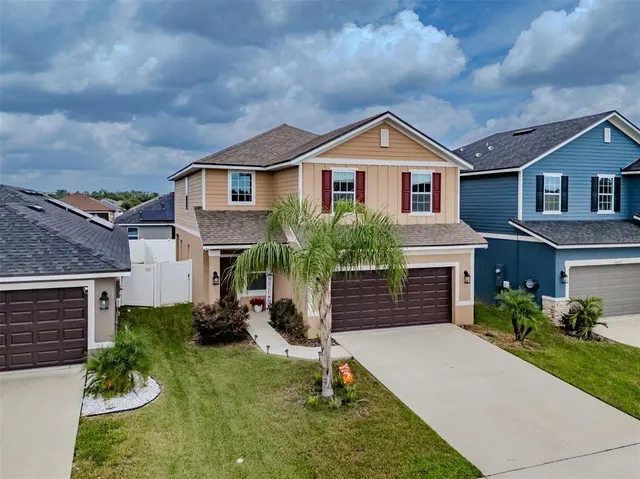 an aerial view of a house with a yard
