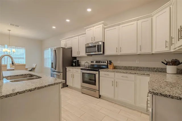 a kitchen with stainless steel appliances a refrigerator stove microwave and sink
