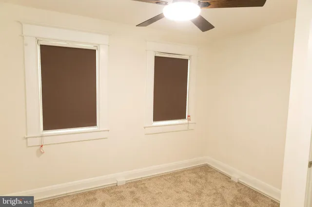 a kitchen with granite countertop white cabinets and a sink