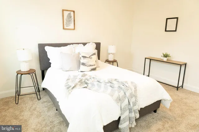 a bed sitting in a bedroom with a lamp