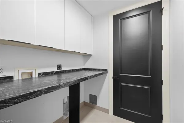 a kitchen with stainless steel appliances granite countertop a sink and a refrigerator