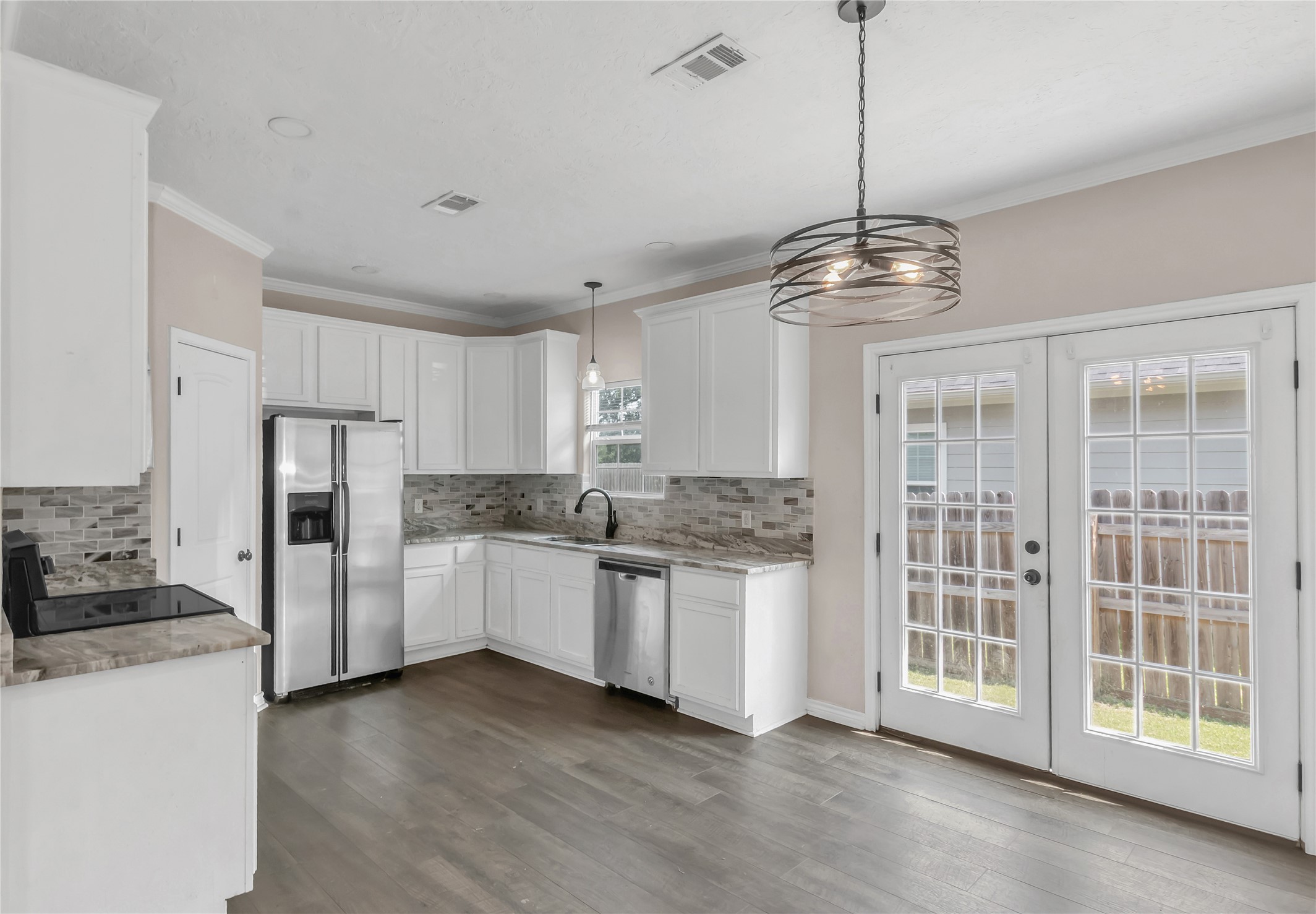 904 New York Street Bryan, TX 77803 - Photo 3 of 11 a kitchen with stainless steel appliances granite countertop a refrigerator and a stove top oven