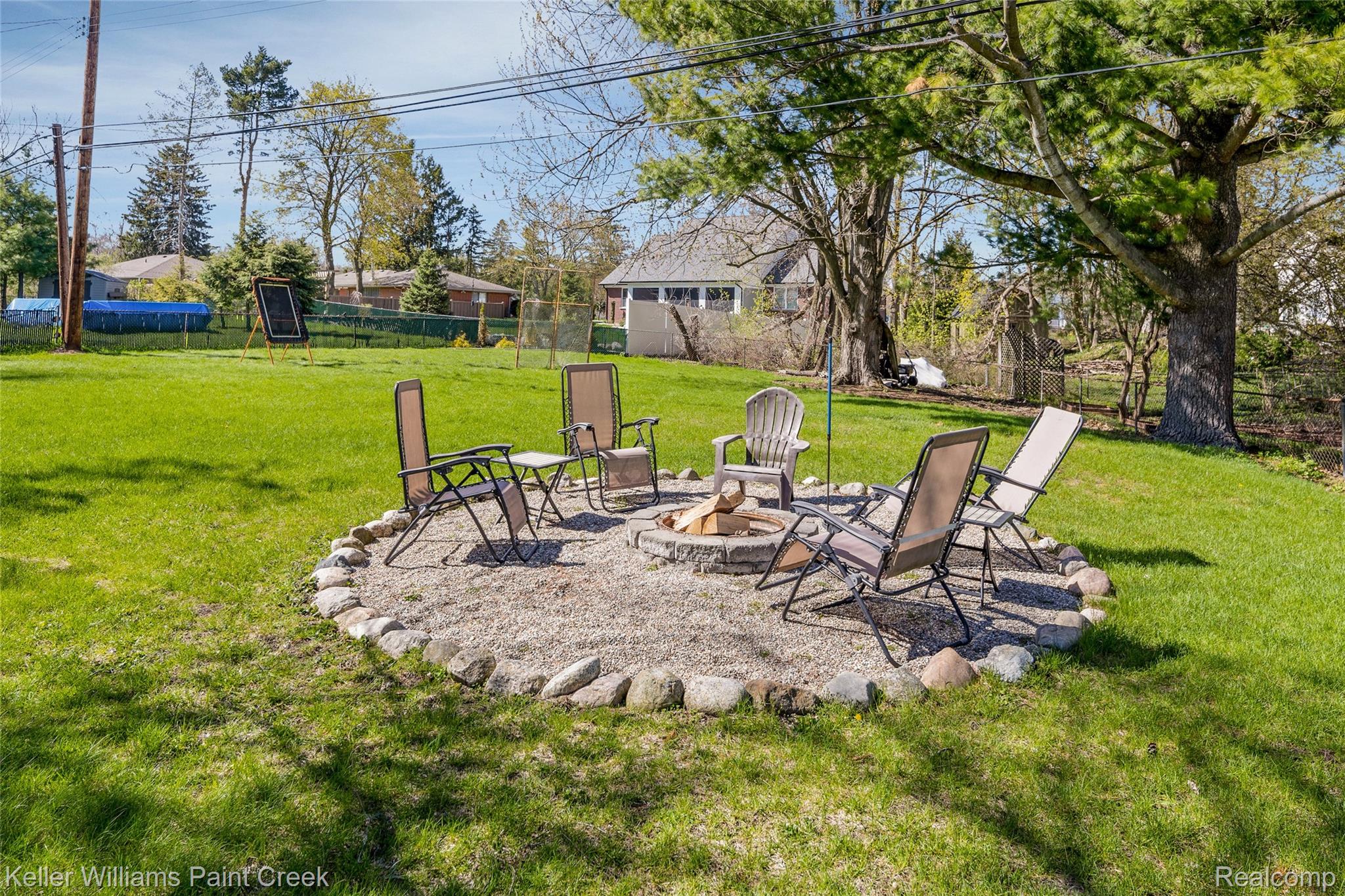 310 Elmhill Road Rochester, MI 48306 - Photo 31 of 37 Fenced backyard featuring an outdoor fire pit and a patio area