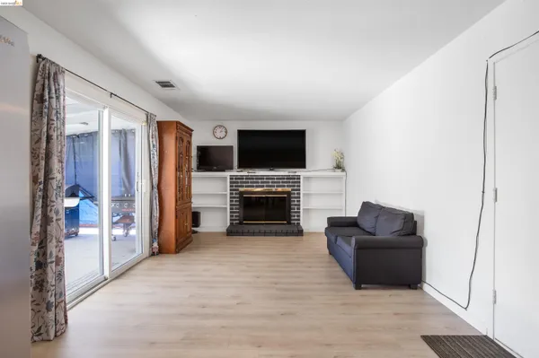 a living room with furniture a fireplace and a flat screen tv