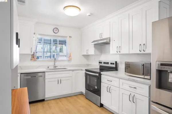 a kitchen with a sink stove and cabinets