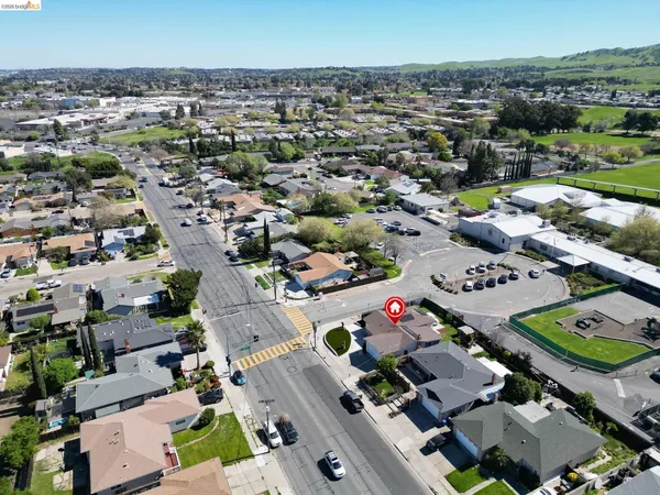 an aerial view of a houses with a swimming pool