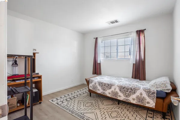 a living room with furniture a flat screen tv and a window