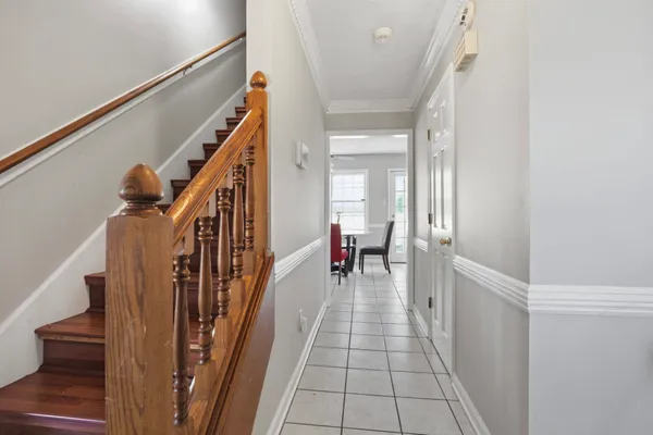 a view of a hallway with wooden floor and staircase