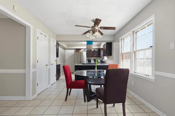 a dining room with furniture and window