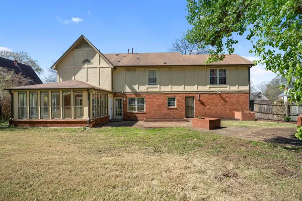 a view of a house with a yard and sitting area