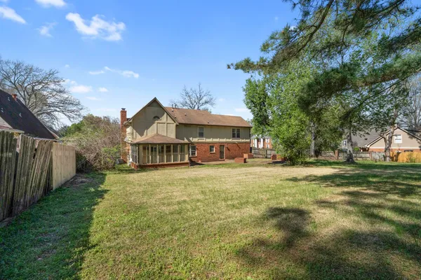a front view of house with yard and green space