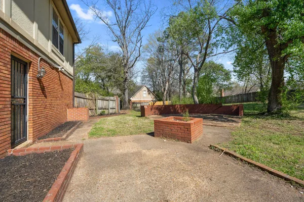 a view of a backyard with sitting area