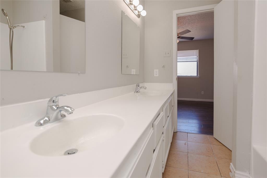 2821 Wimbledon Court Garland, TX 75041 - Photo 11 of 27 a en suite bathroom with a sink and a large mirror