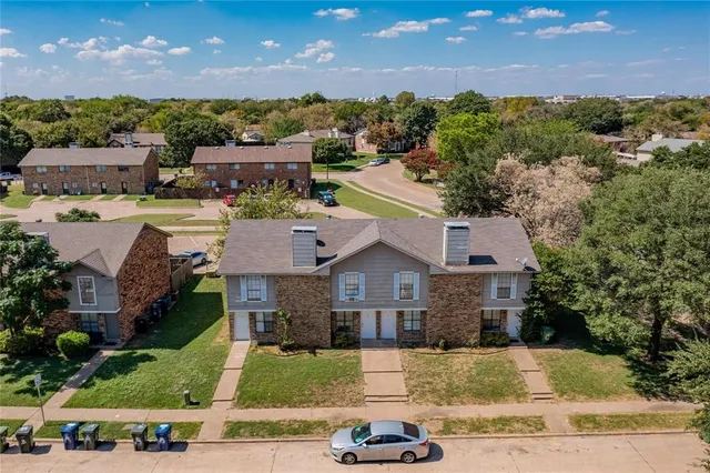 an aerial view of a house with a yard