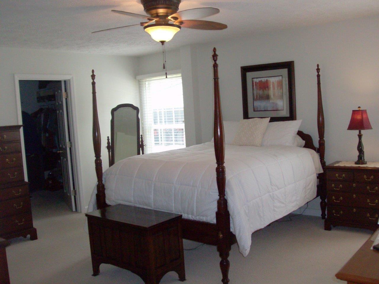 12929 Callaway Road Callaway, VA 24067 - Photo 11 of 59 a bedroom with a bed and a chandelier