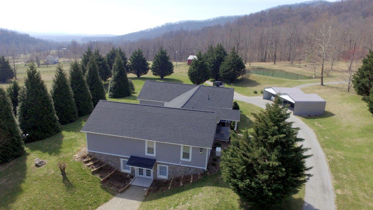 12929 Callaway Road Callaway, VA 24067 - Photo 38 of 59 an aerial view of a house with garden space and outdoor seating