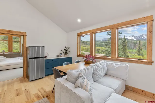 a bedroom with furniture and a large window