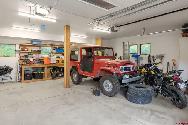 a view of a hallway that has toilet and a view of bathroom