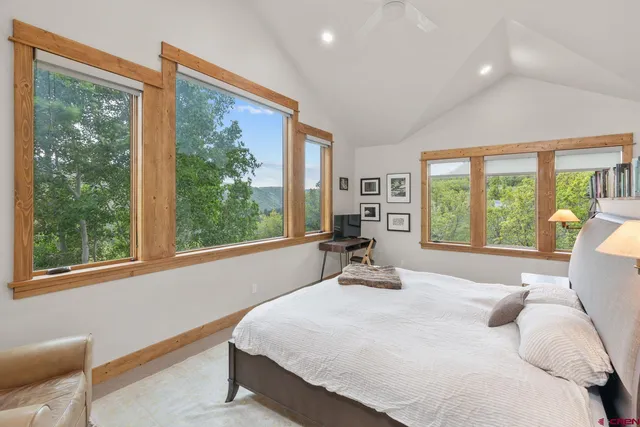 a bedroom with a bed and large window