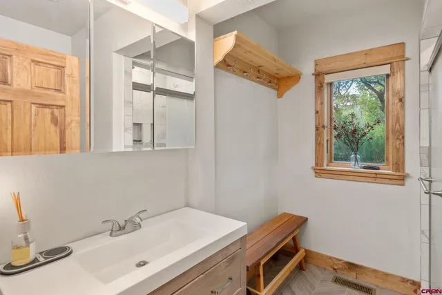 a living room with patio furniture and a potted plant