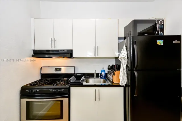 a kitchen with stainless steel appliances granite countertop a stove a refrigerator and a refrigerator