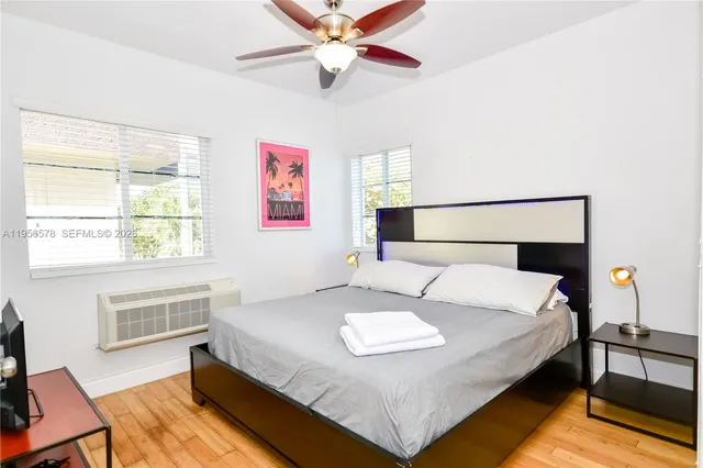 a bedroom with a bed lamp and a window