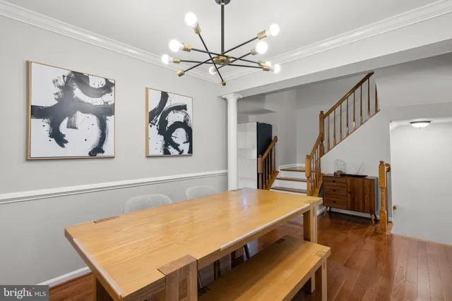a view of a room with furniture and wooden floor