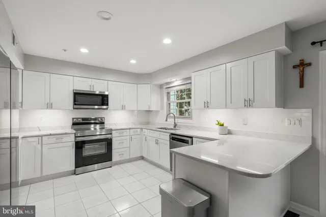 a kitchen that has a sink and a stove top oven
