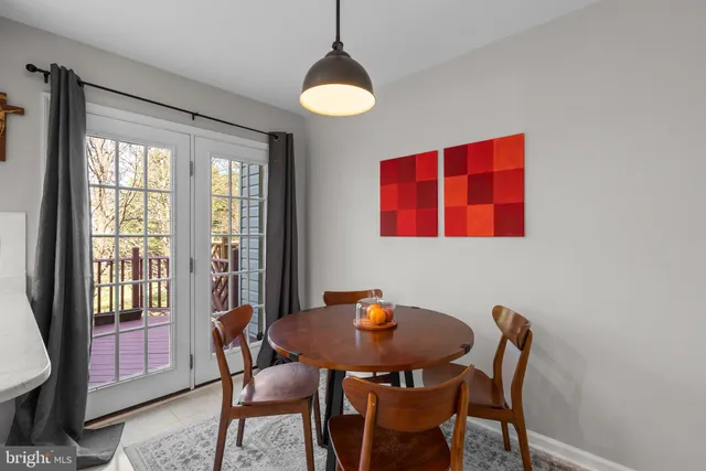 a view of a dining room with furniture and a window