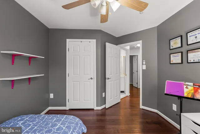 a view of bedroom with a bed and wooden floor
