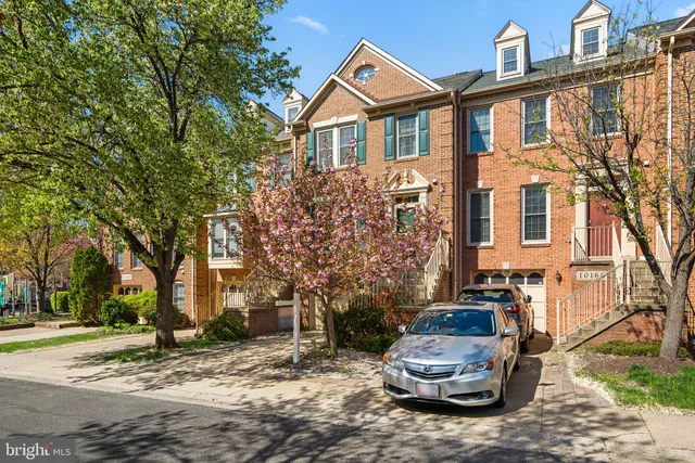 a car parked in front of a white house