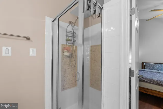 a bathroom with a granite countertop shower and a sink