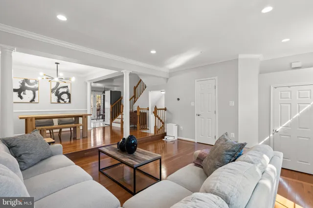 a living room with furniture and wooden floor