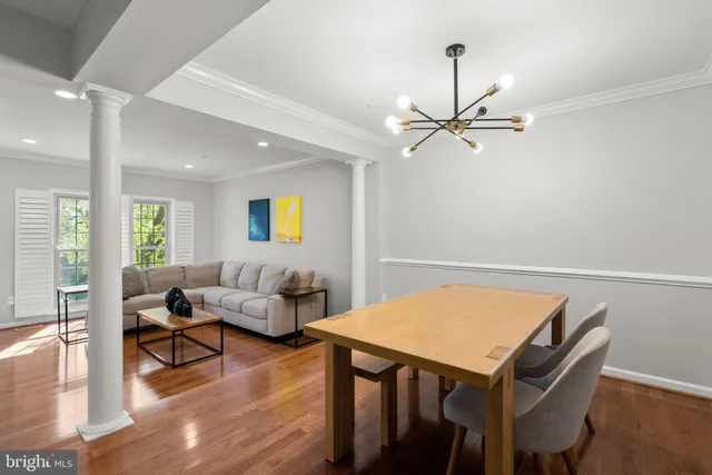 a living room with furniture a table and wooden floor