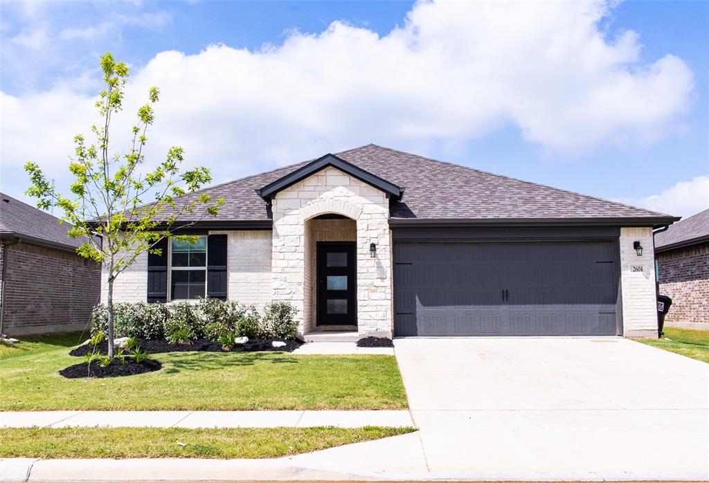 2604 Freeman Street Anna, TX 75409 - Photo 1 of 18 a front view of a house with garden