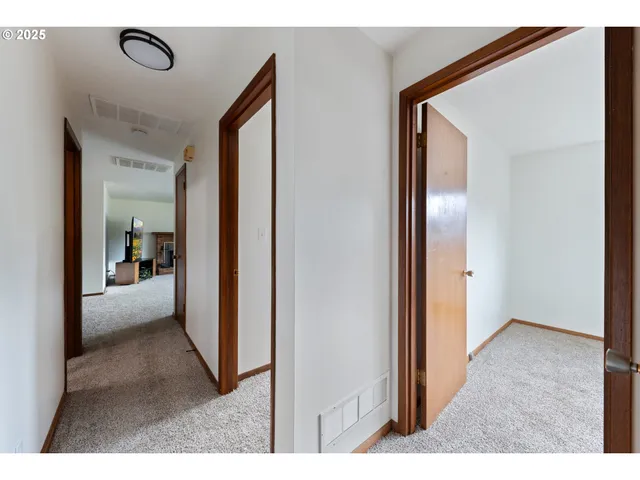 a view of a hallway and a livingroom with furniture