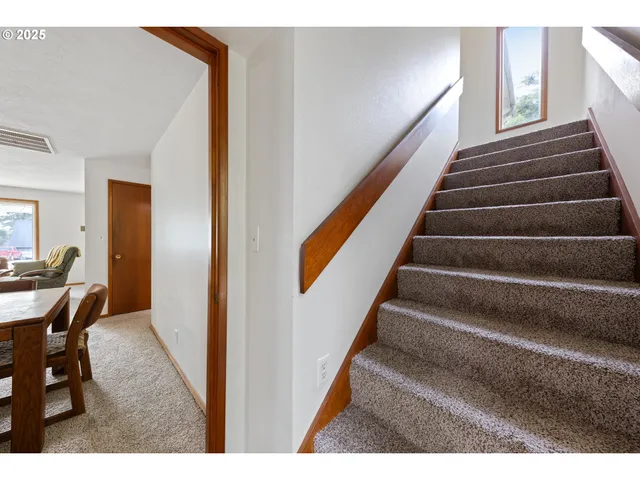 a view of a room with wooden floor and windows