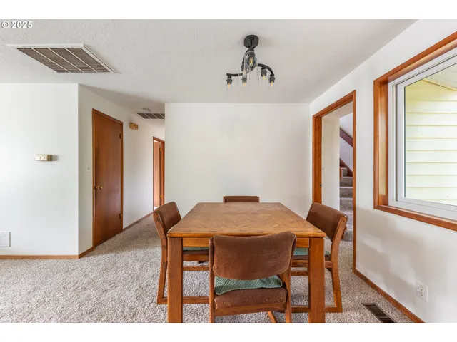 a view of a dining room with furniture and window