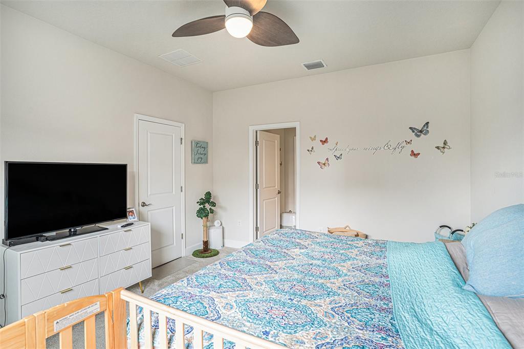 19056 Heavenside Ct Spring Hill Spring Hill, FL 34610 - Photo 12 of 25 a bedroom with furniture and flat screen tv