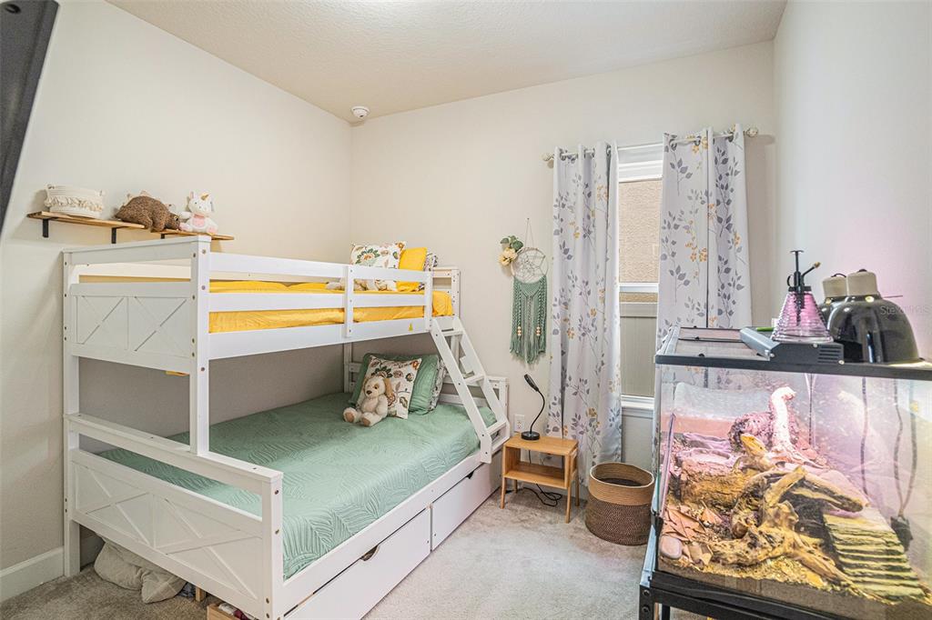 19056 Heavenside Ct Spring Hill Spring Hill, FL 34610 - Photo 15 of 25 a room with furniture and a bed