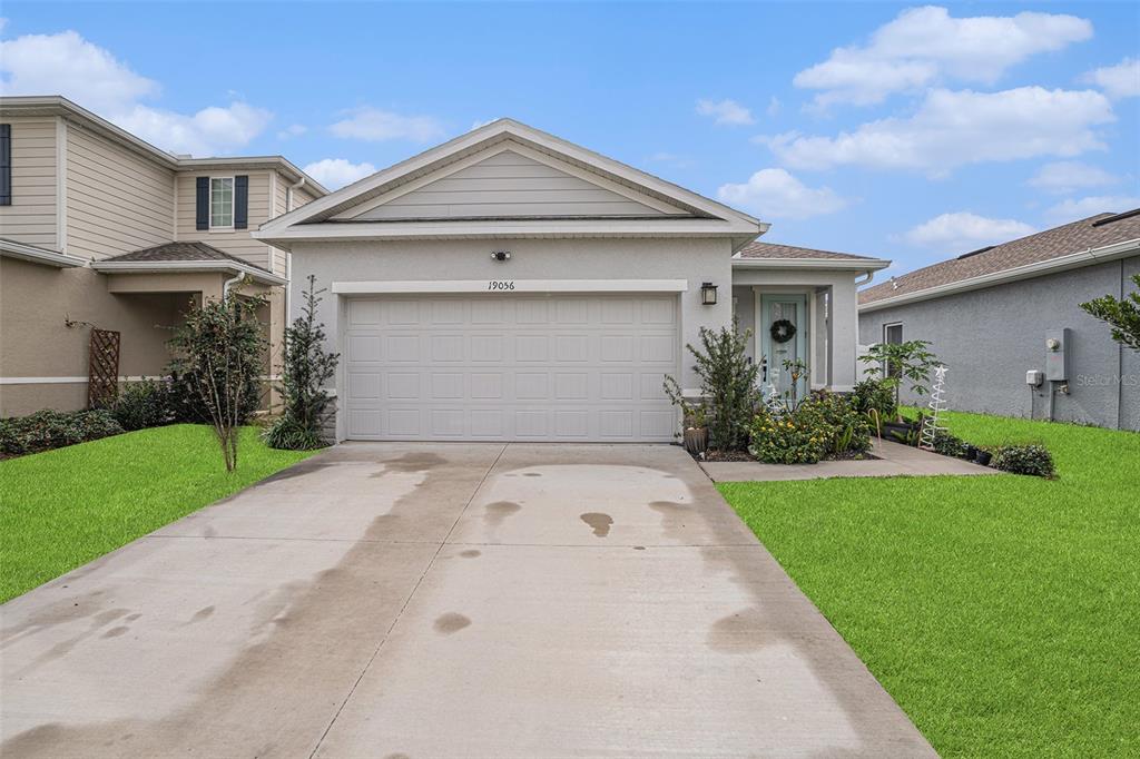 19056 Heavenside Ct Spring Hill Spring Hill, FL 34610 - Photo 25 of 25 a front view of a house with a yard and garage