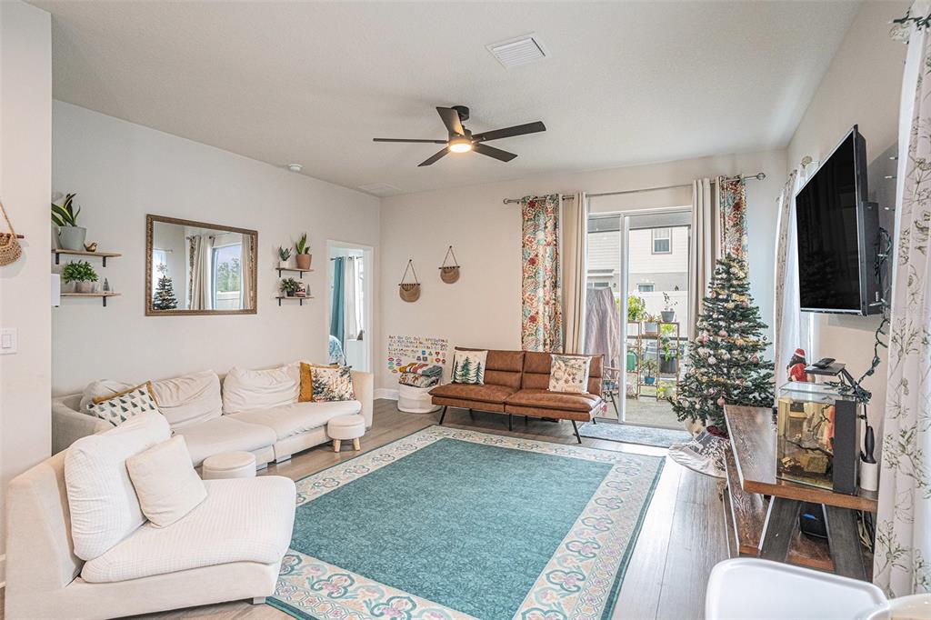 19056 Heavenside Ct Spring Hill Spring Hill, FL 34610 - Photo 3 of 25 a living room with furniture and a flat screen tv