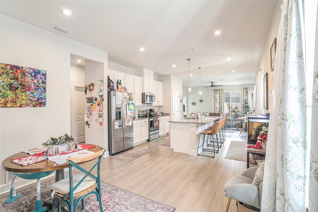 19056 Heavenside Ct Spring Hill Spring Hill, FL 34610 - Photo 6 of 25 a living room with stainless steel appliances kitchen island granite countertop furniture and a kitchen view