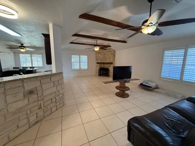 a room with gym equipment and a fireplace