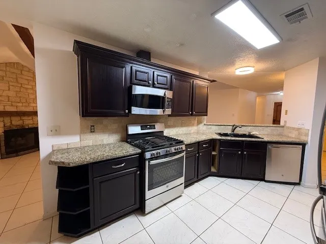 a bathroom with a granite countertop sink a mirror and a shower