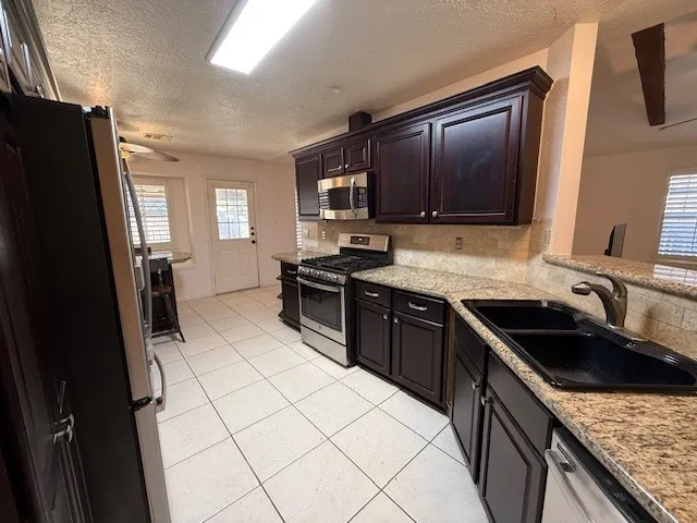 a kitchen with a stove and a microwave