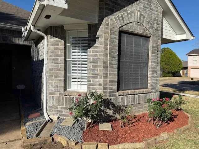 a view of an empty room and a chandelier fan