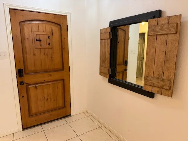 a kitchen with granite countertop a refrigerator and a stove top oven